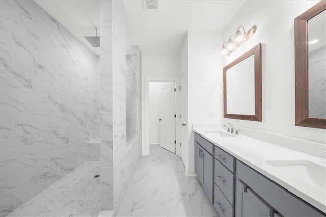 bathroom featuring vanity and tiled shower