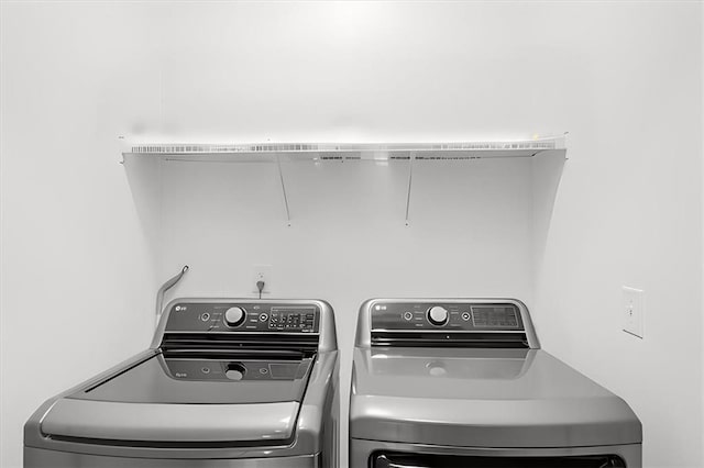 clothes washing area with independent washer and dryer