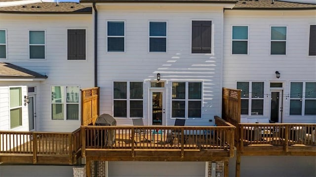 back of property with a wooden deck