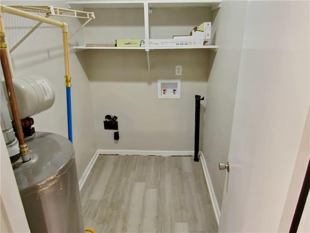 laundry room featuring hookup for a washing machine, light hardwood / wood-style floors, and hookup for an electric dryer