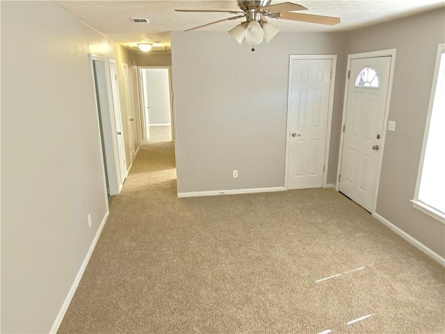 carpeted empty room with ceiling fan