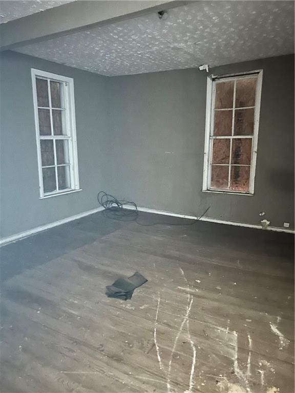 empty room featuring hardwood / wood-style floors and a textured ceiling