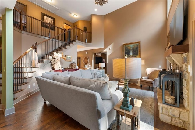 4 Bluff Ct, Cartersville, GA 30120 - living area featuring hardwood / wood-style flooring, stairs, a stone fireplace, and a towering ceiling