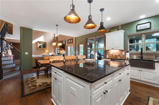 4 Bluff Ct, Cartersville, GA 30120 - kitchen with dark wood-type flooring, tasteful backsplash, white cabinets, a kitchen island, and decorative light fixtures