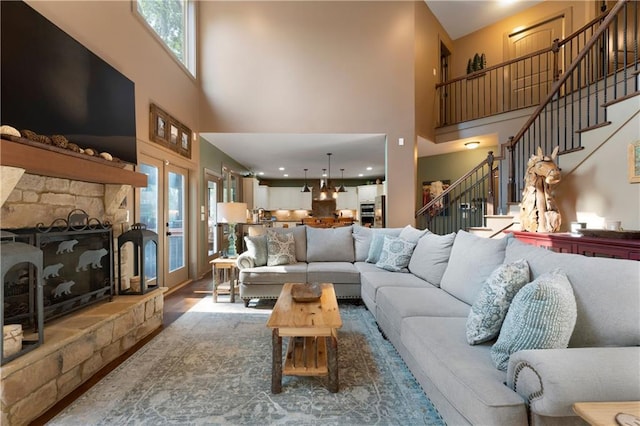 4 Bluff Ct, Cartersville, GA 30120 - living area with a high ceiling, healthy amount of natural light, a fireplace, and stairs