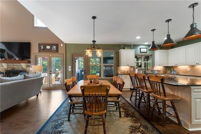 4 Bluff Ct, Cartersville, GA 30120 - dining space featuring french doors, dark wood-style flooring, recessed lighting, a towering ceiling, and a fireplace