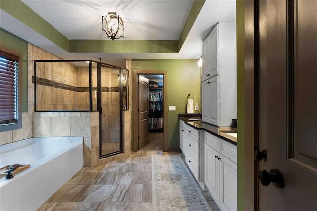4 Bluff Ct, Cartersville, GA 30120 - full bath featuring vanity, a stall shower, a bath, a chandelier, and a walk in closet