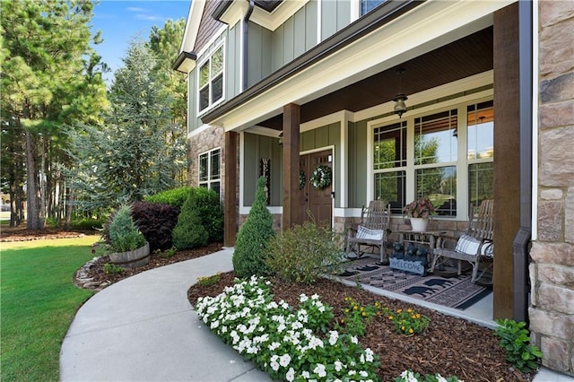 4 Bluff Ct, Cartersville, GA 30120 - doorway to property with board and batten siding, a porch, stone siding, and a yard