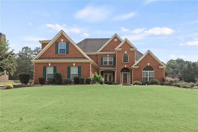 view of front of property with brick siding and a front yard