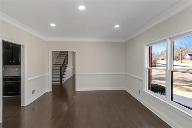 spare room featuring dark wood finished floors, crown molding, recessed lighting, and baseboards