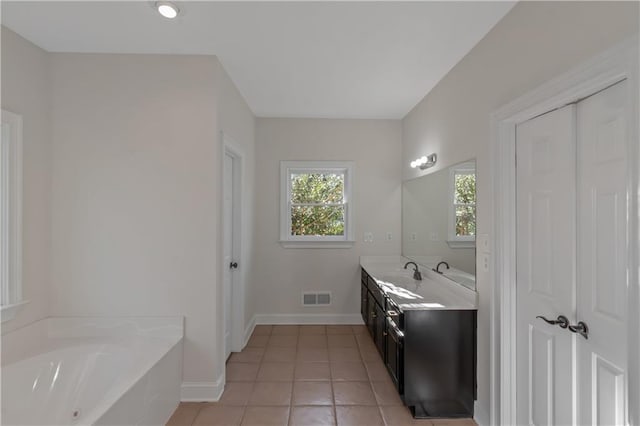 full bathroom with vanity, visible vents, baseboards, tile patterned flooring, and a bath