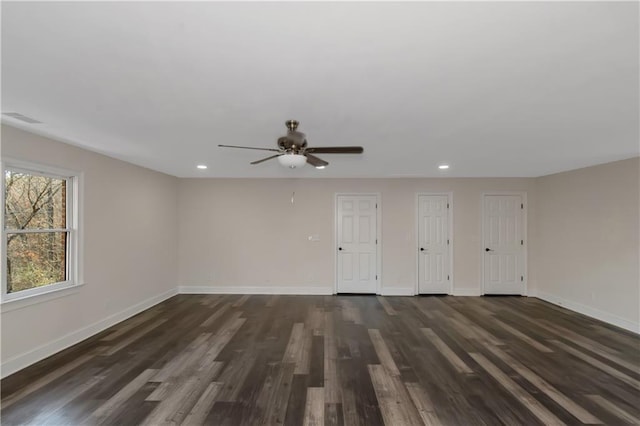 spare room featuring dark wood-type flooring, recessed lighting, baseboards, and visible vents