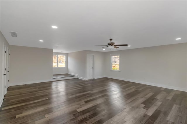 unfurnished room with dark wood-style floors, visible vents, recessed lighting, and baseboards