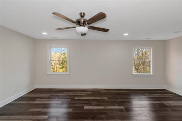 spare room featuring a ceiling fan, recessed lighting, wood finished floors, and baseboards