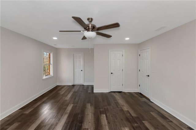 unfurnished bedroom with recessed lighting, baseboards, and dark wood-style flooring