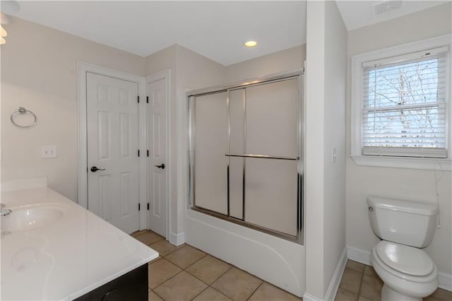 full bath featuring tile patterned flooring, visible vents, shower / bath combination with glass door, and a sink