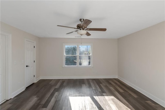 unfurnished bedroom featuring baseboards, a ceiling fan, and dark wood-style flooring