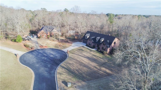 birds eye view of property featuring a view of trees