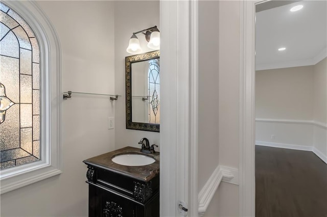 bathroom with vanity, crown molding, and recessed lighting