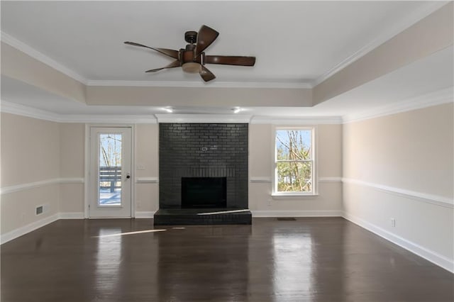 unfurnished living room featuring a wealth of natural light, visible vents, and a tray ceiling