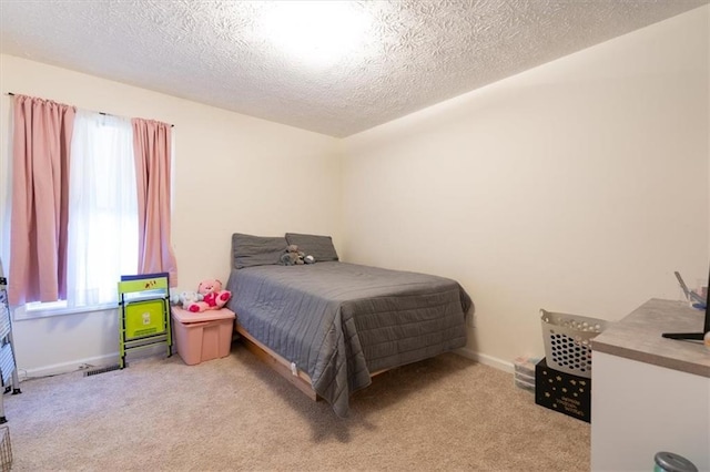 carpeted bedroom with a textured ceiling