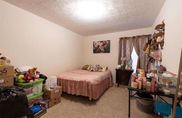 carpeted bedroom featuring a textured ceiling