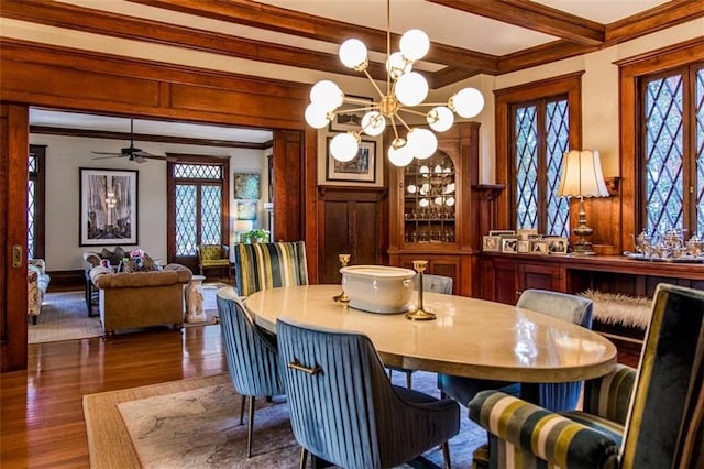 dining room featuring a chandelier, beam ceiling, crown molding, and dark wood-style flooring