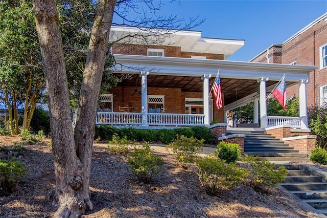 view of front of property with brick siding and covered porch