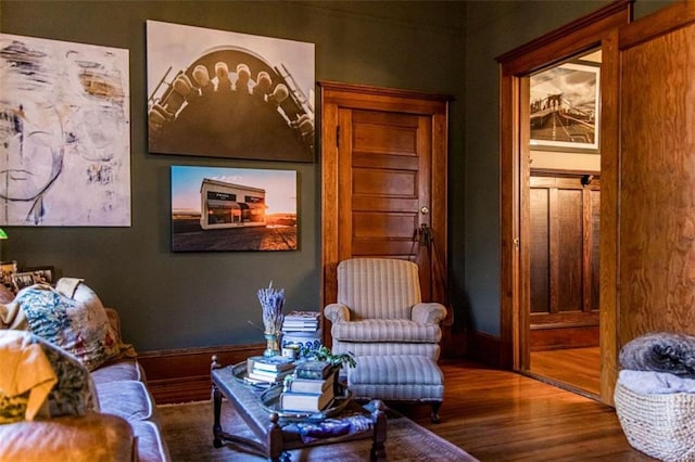 sitting room featuring baseboards and wood finished floors