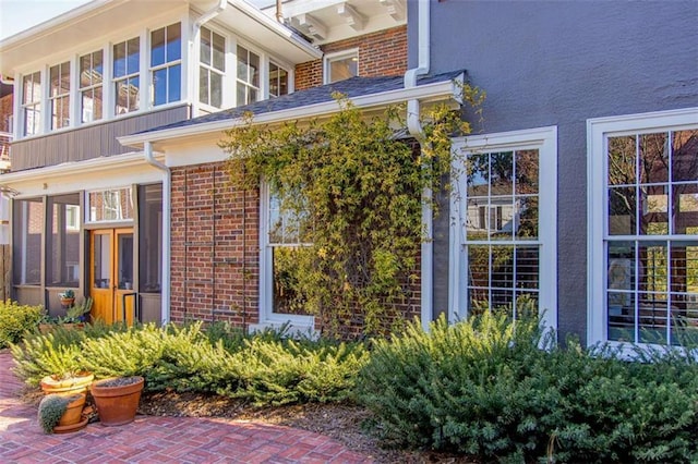 view of property exterior with brick siding