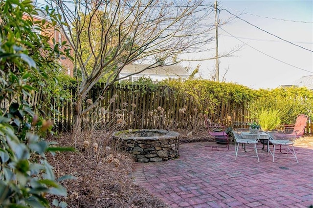 view of patio featuring fence and an outdoor fire pit