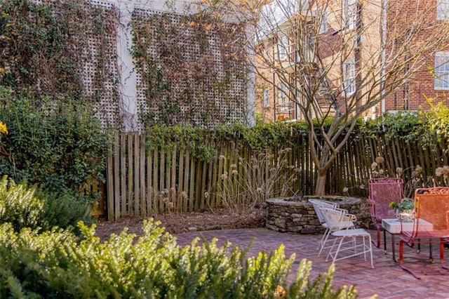 view of patio with a fenced backyard and an outdoor fire pit