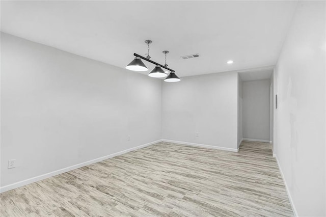 spare room featuring light wood-type flooring