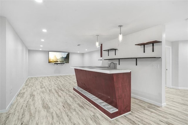 kitchen featuring light wood-type flooring and decorative light fixtures