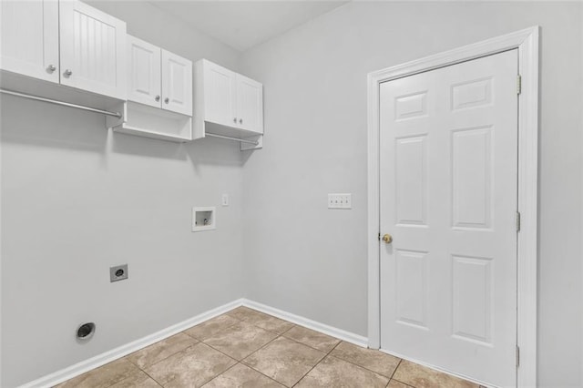 laundry room featuring hookup for an electric dryer, washer hookup, light tile patterned floors, and cabinets