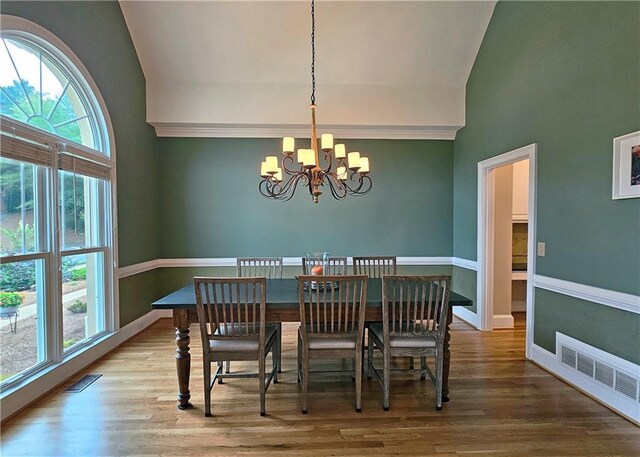 215 Settindown Ct, Roswell, GA 30075 - dining space with a chandelier, healthy amount of natural light, wood finished floors, and high vaulted ceiling
