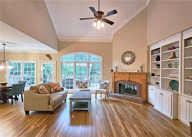 215 Settindown Ct, Roswell, GA 30075 - living area featuring ornamental molding, wood finished floors, healthy amount of natural light, a ceiling fan, and high vaulted ceiling