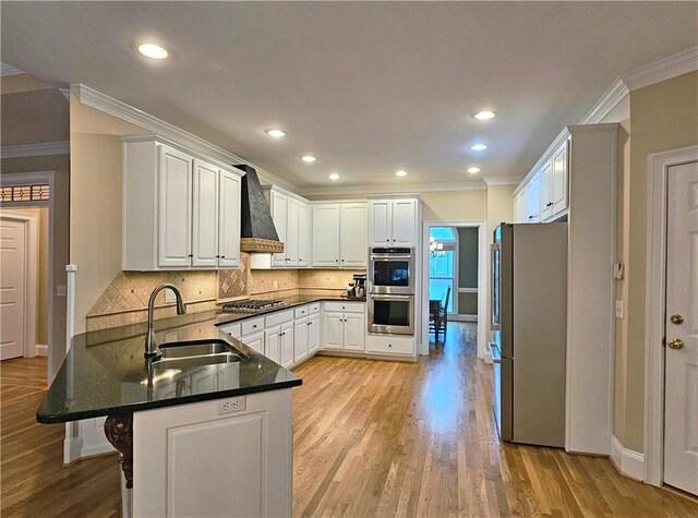 215 Settindown Ct, Roswell, GA 30075 - kitchen with appliances with stainless steel finishes, custom exhaust hood, a peninsula, ornamental molding, and white cabinetry