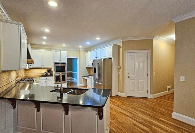 215 Settindown Ct, Roswell, GA 30075 - kitchen featuring appliances with stainless steel finishes, a peninsula, crown molding, dark countertops, and recessed lighting