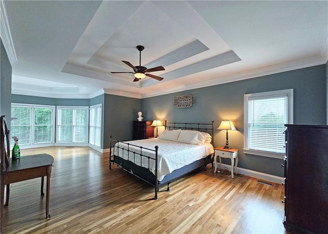 215 Settindown Ct, Roswell, GA 30075 - bedroom featuring a tray ceiling, light wood-style floors, multiple windows, and ornamental molding