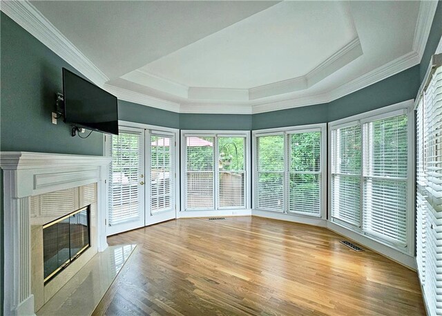 215 Settindown Ct, Roswell, GA 30075 - unfurnished living room featuring ornamental molding, wood finished floors, a fireplace, and a tray ceiling