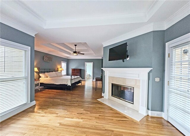 215 Settindown Ct, Roswell, GA 30075 - bedroom with a tray ceiling, light wood-style floors, a high end fireplace, crown molding, and ceiling fan