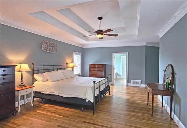 215 Settindown Ct, Roswell, GA 30075 - bedroom featuring a raised ceiling, ornamental molding, wood finished floors, and ceiling fan