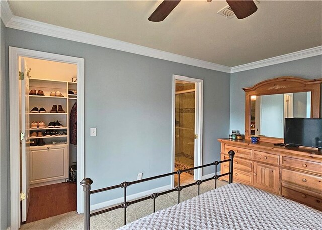 215 Settindown Ct, Roswell, GA 30075 - bedroom featuring crown molding, carpet, a ceiling fan, and a walk in closet