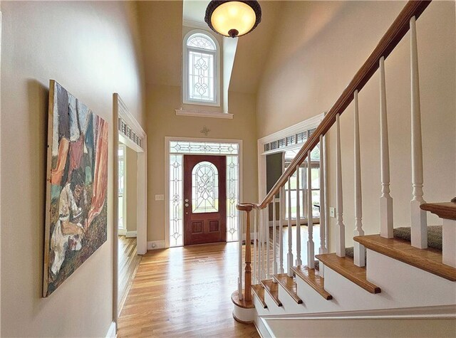 215 Settindown Ct, Roswell, GA 30075 - foyer with a towering ceiling, stairs, and light wood-type flooring