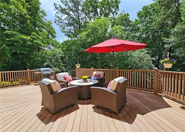 215 Settindown Ct, Roswell, GA 30075 - wooden terrace featuring outdoor dining space, a grill, and view of wooded area