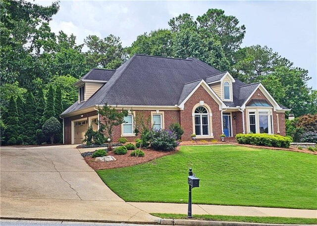 215 Settindown Ct, Roswell, GA 30075 - view of front of home featuring brick siding, concrete driveway, a front yard, and an attached garage