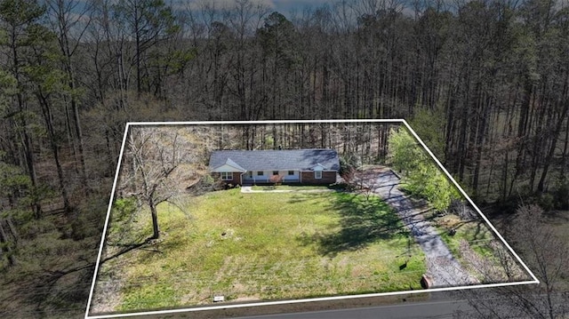 birds eye view of property featuring a wooded view