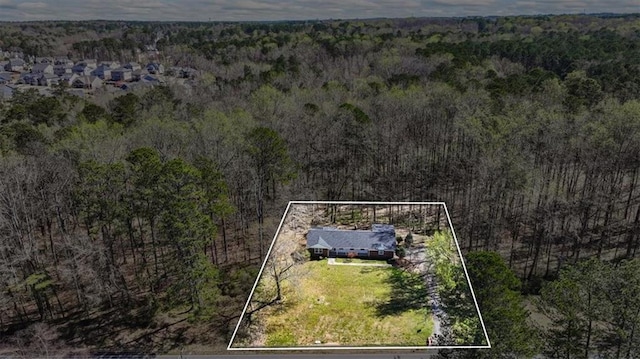 aerial view featuring a wooded view