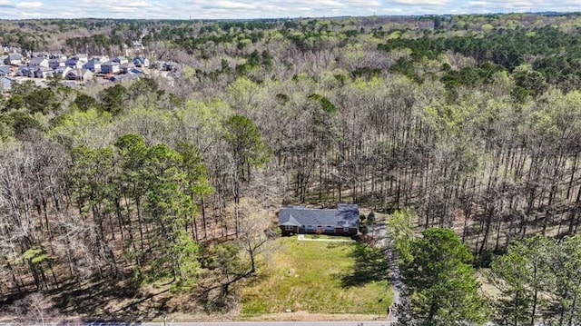 bird's eye view with a wooded view